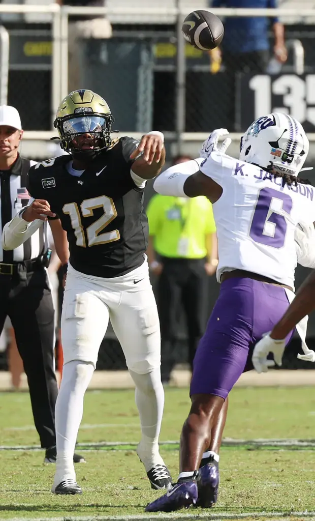 UCF quarterback Keyone Jenkins (12) throws over TCU safety Kylin...