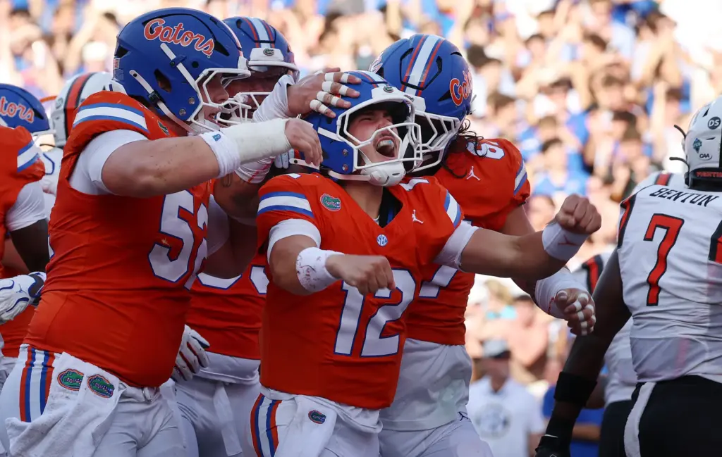 Florida quarterback Aaron Philo (12) screams in celebration after scoring...