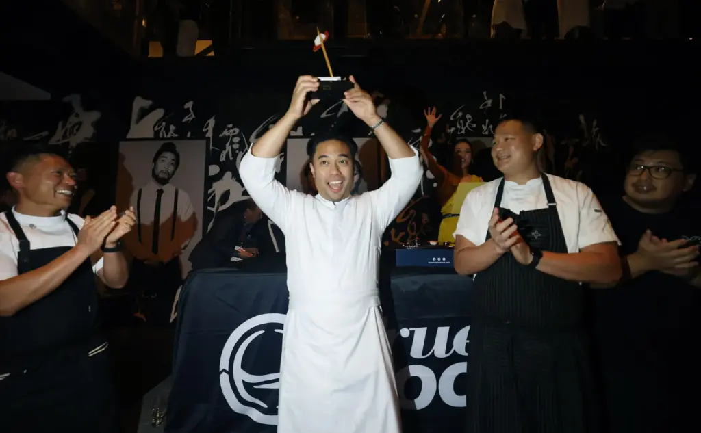 Chef Kevin Abanilla of Okonomi holds aloft the judges award...