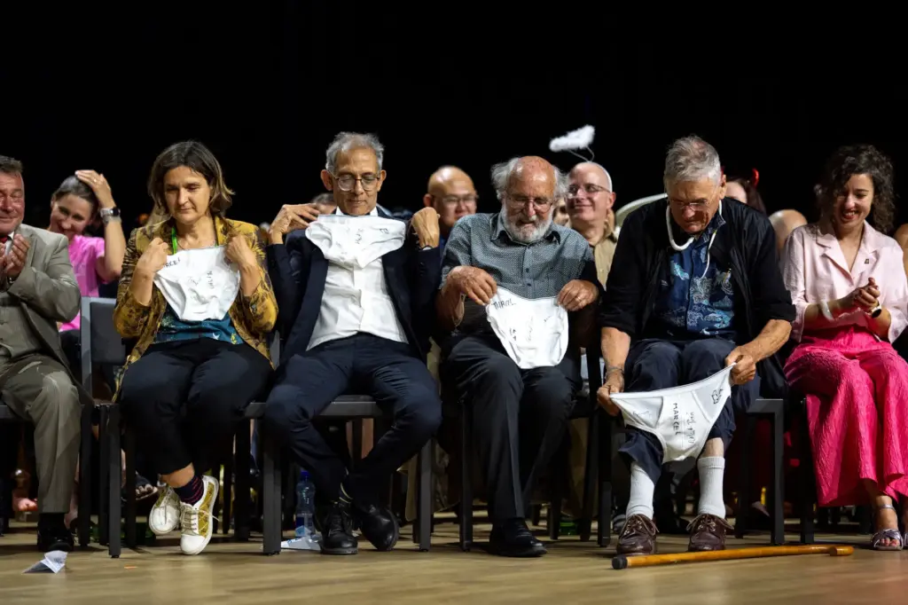 From left, Nobel Prize winners Esther Duflo, Abhijit Banerjee, Michel...