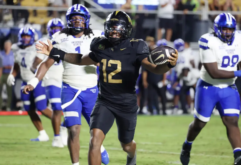 UCF quarterback Keyone Jenkins (12) celebrates as he scores a...