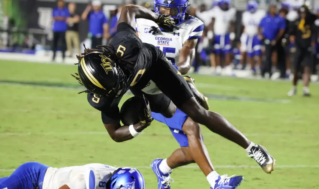 UCF wide receiver Waden Charles (9) leaps into the endzone...