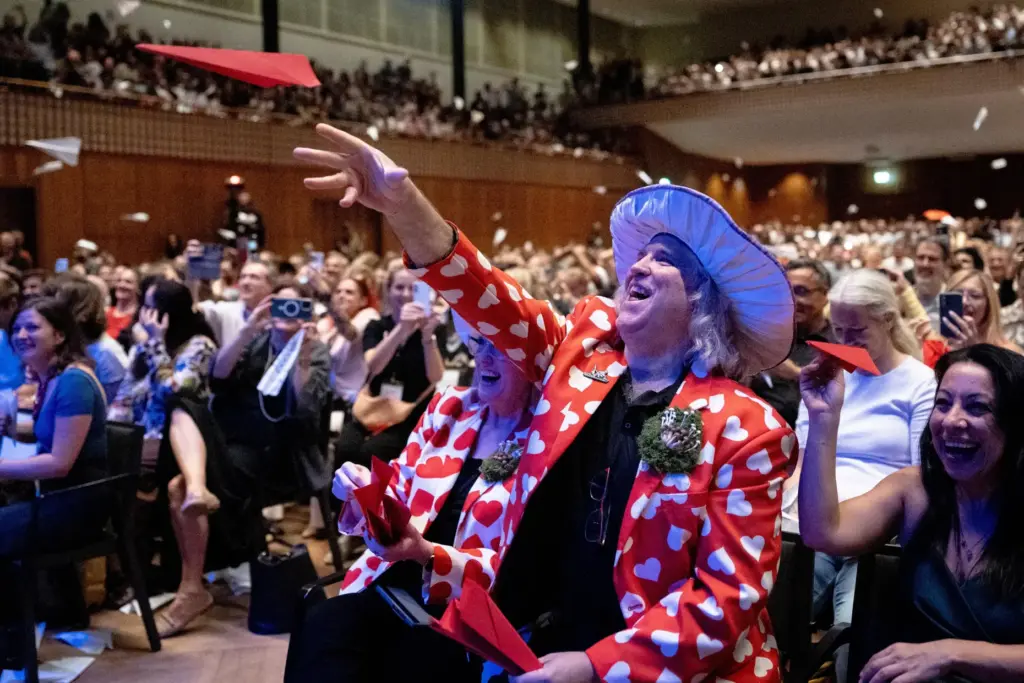 Spectators throw paper planes during the Ig Nobel Prize ceremony...