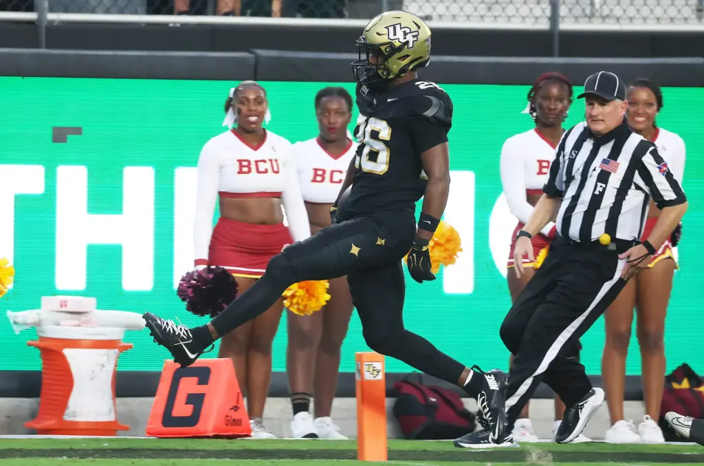UCF running back Duke Watson high steps into the endzone...