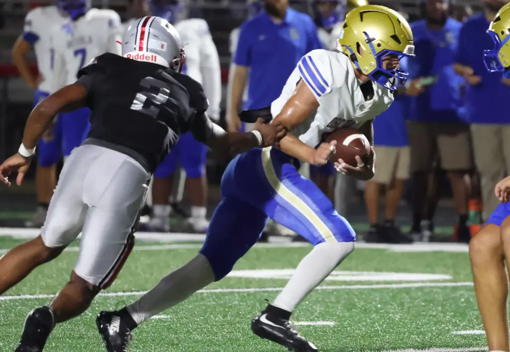 Osceola player Josue Rivera (9) evades Lake Mary player Braylon...