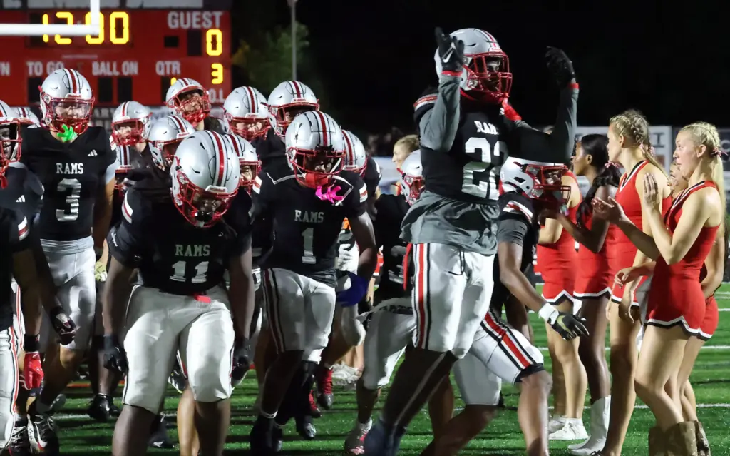 Lake Mary players run onto the field for the Osceola...