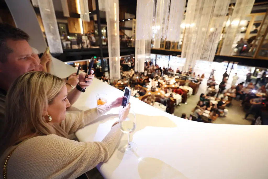 Guests take photos during the Sushi Showdown at Morimoto Asia...