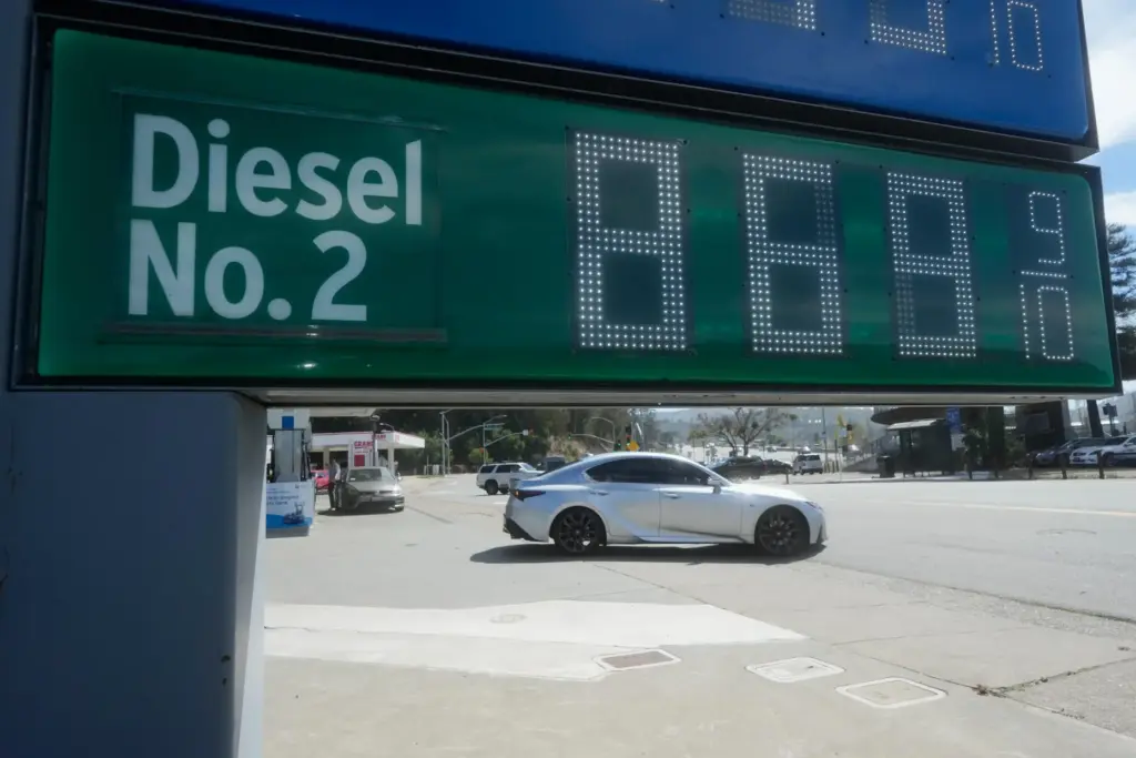 The cost of diesel is displayed on a gasoline price board at a gas station.