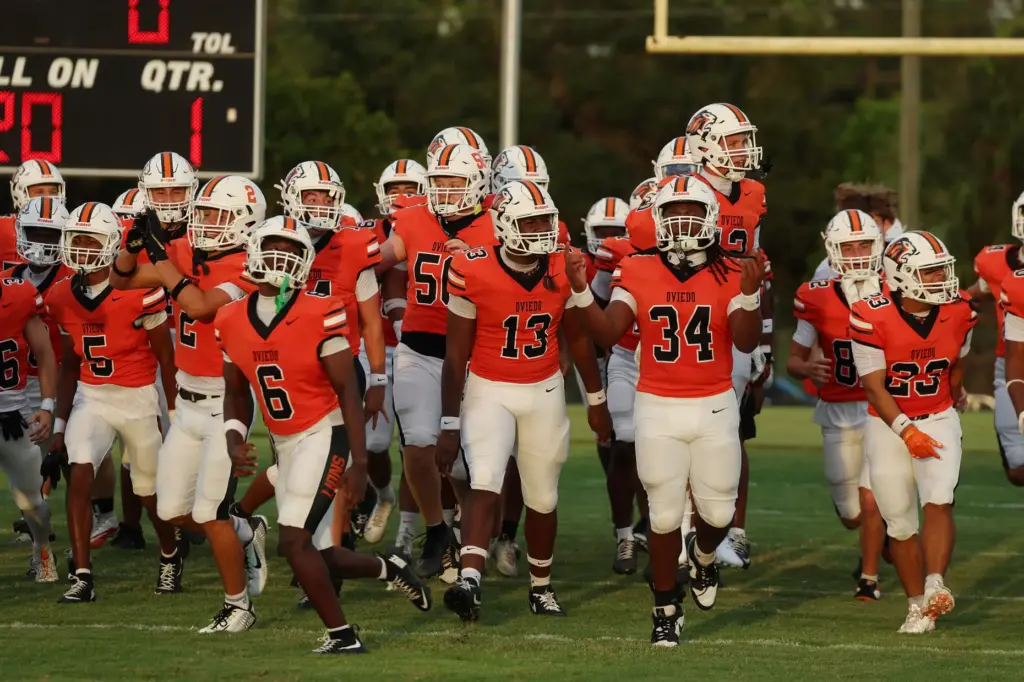 Oviedo players run onto the field for the Oviedo High...
