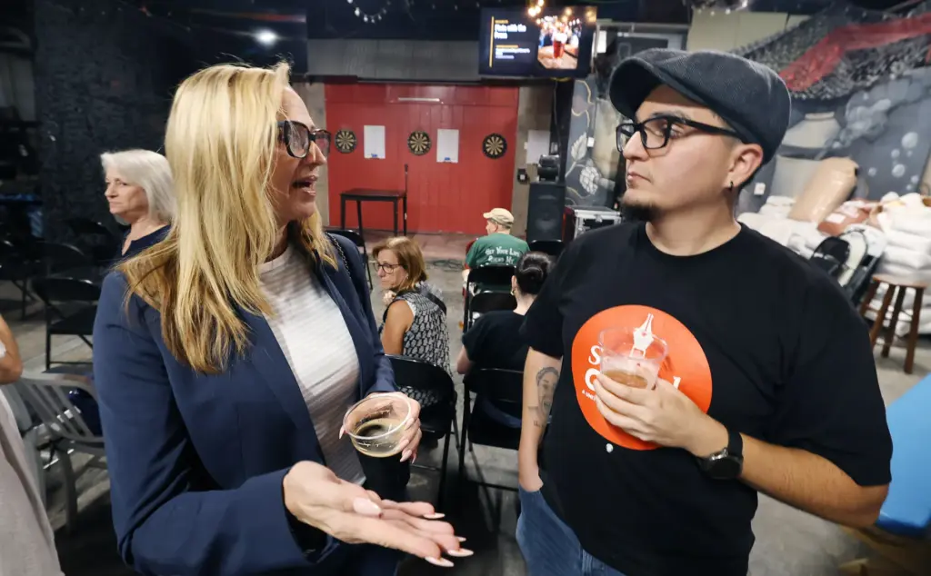 Orlando Sentinel reporters Sarah Kinbar, left, and Cristobal Reyes chat...