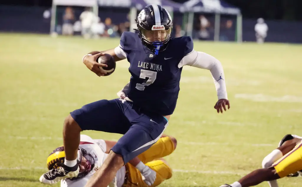 Lake Nona quarterback Elijah Nickerson (7) runs for a touchdown...