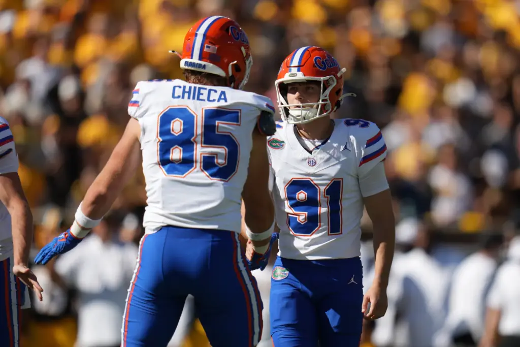 Florida kicker Patrick Durkin (91) is congratulated by tight end...