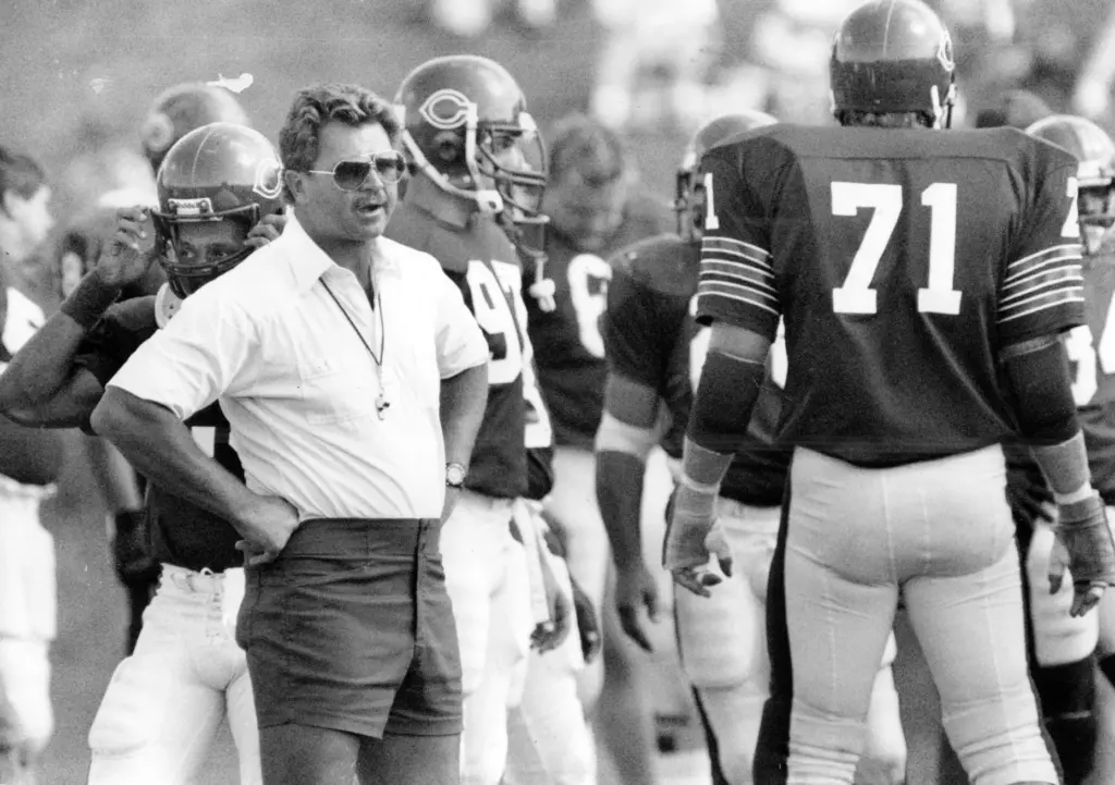 Coach Mike Ditka surrounded by his Bears on Aug. 14,...