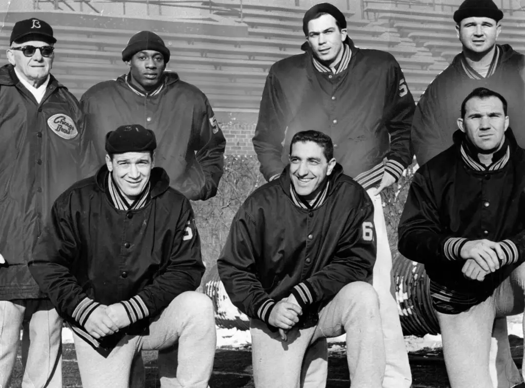 Coach George Halas stands proudly with six members of the...