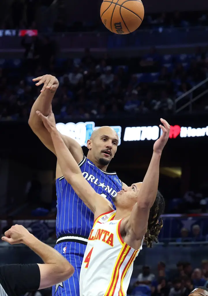 Orlando guard Jalen Suggs (top) wins a jump ball with...