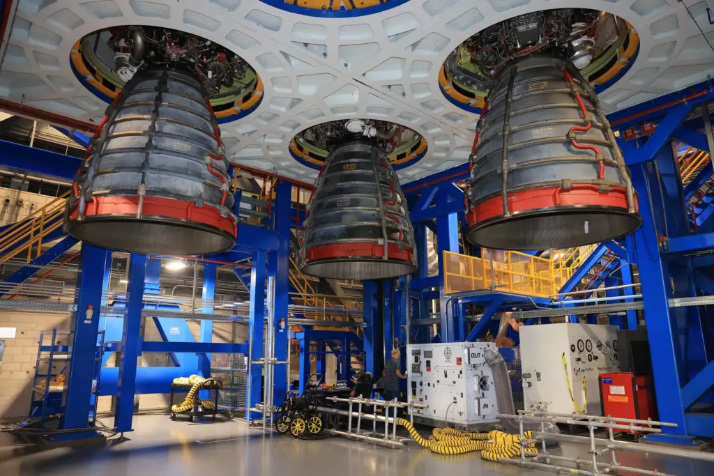 Technicians install three of four RS-25 SLS (Space Launch System)...