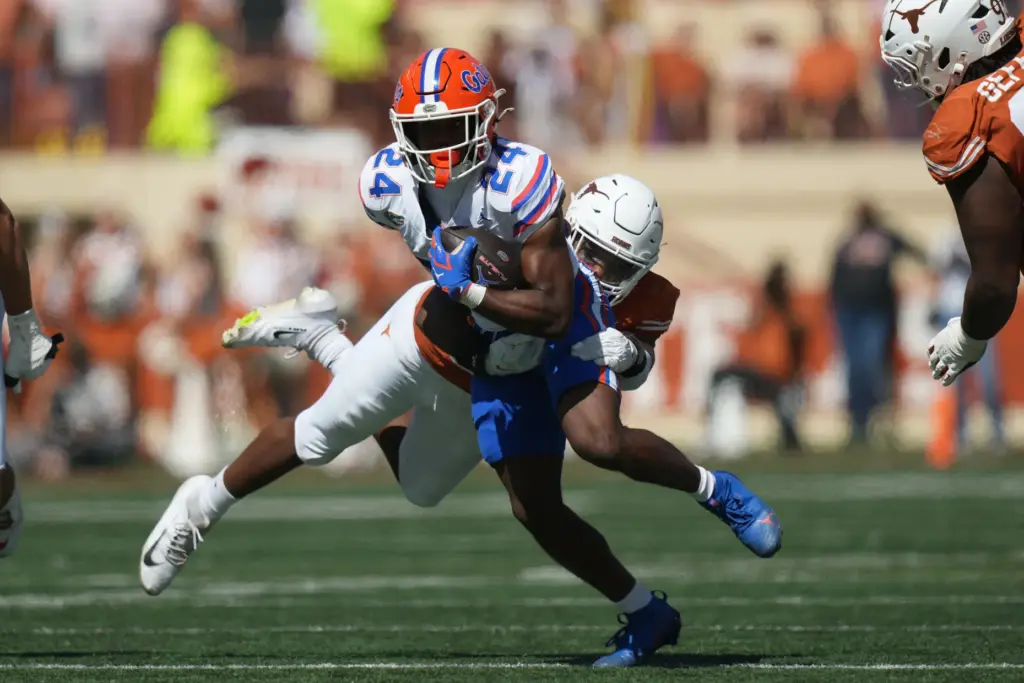 Florida running back London Montgomery (24) is hit by Texas...