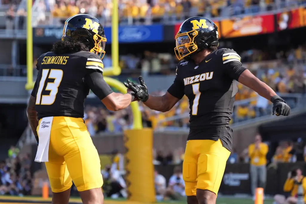 Missouri wide receiver Donovan Olugbode (1) is congratulated by quarterback...