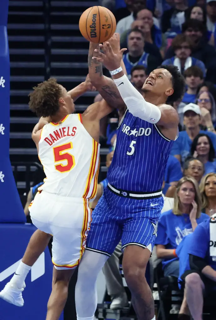 Orlando forward Paolo Banchero (right) battles Atlanta forward Dyson Daniels...