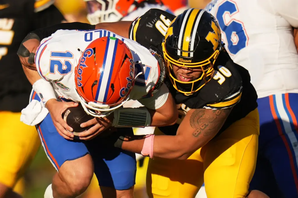 Florida quarterback Aaron Philo (12) is sacked by Missouri defensive...