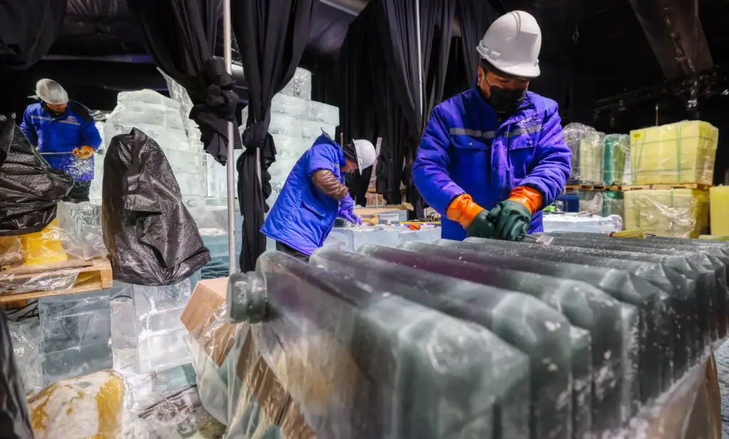Master ice artisans from Harbin, China, at work during a...