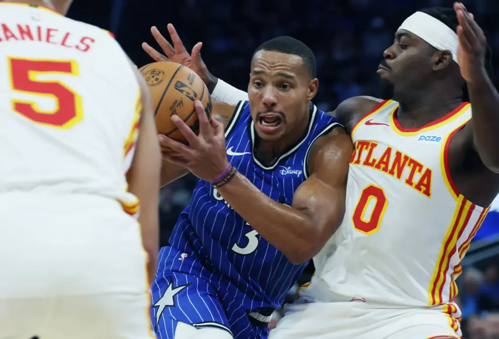 Orlando guard Desmond Bane (3) shoves past Atlanta guard Luguentz...