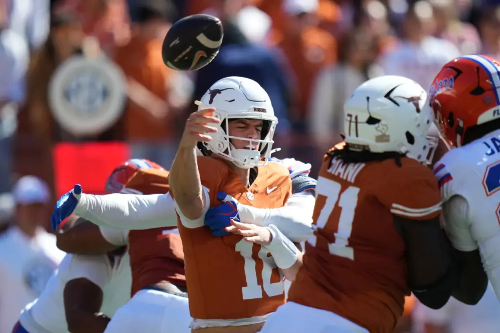 Texas quarterback Arch Manning (16) is hit by Florida linebacker...