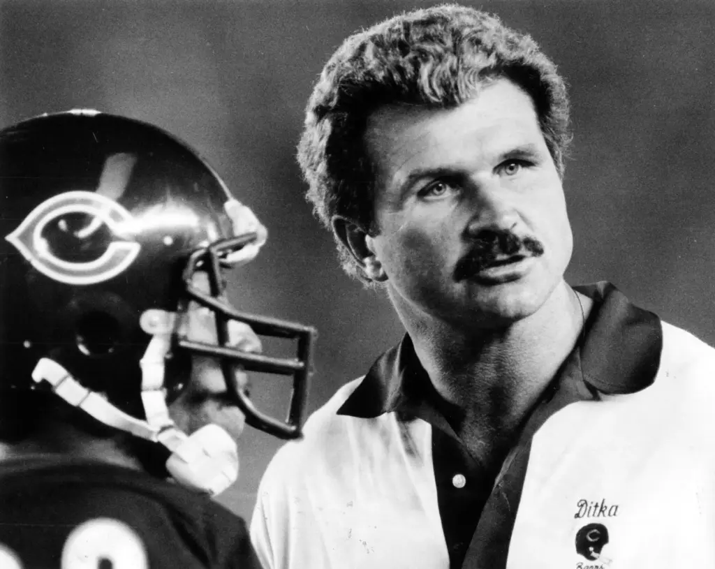 Bears’ coach Mike Ditka has to watch the goings on...