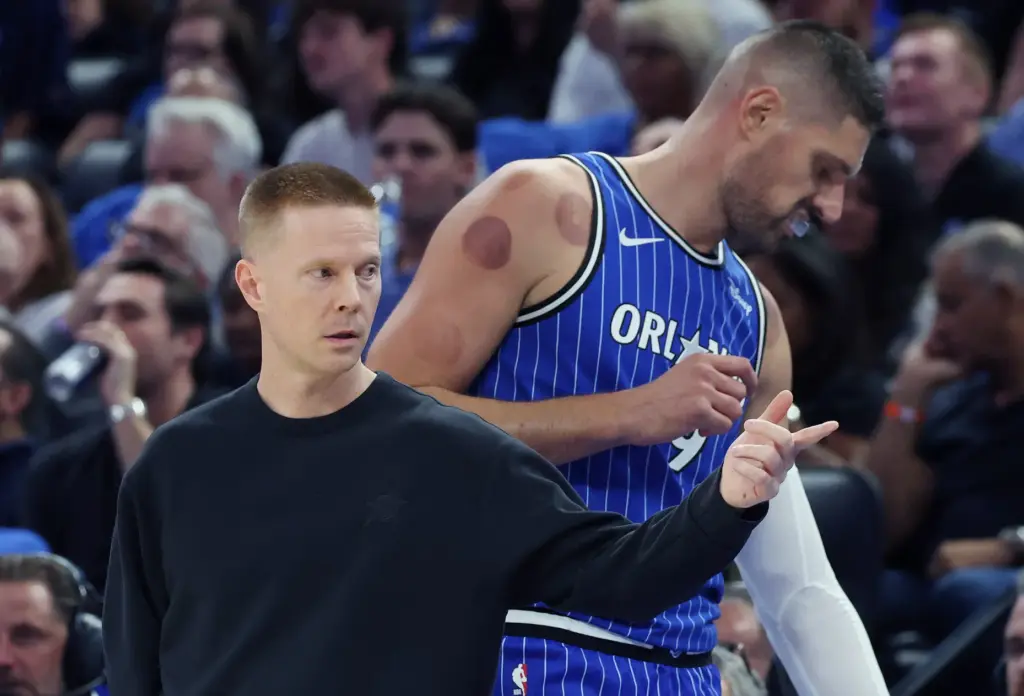 Orlando coach Sean Sweeney coaches in front of center Nikola...