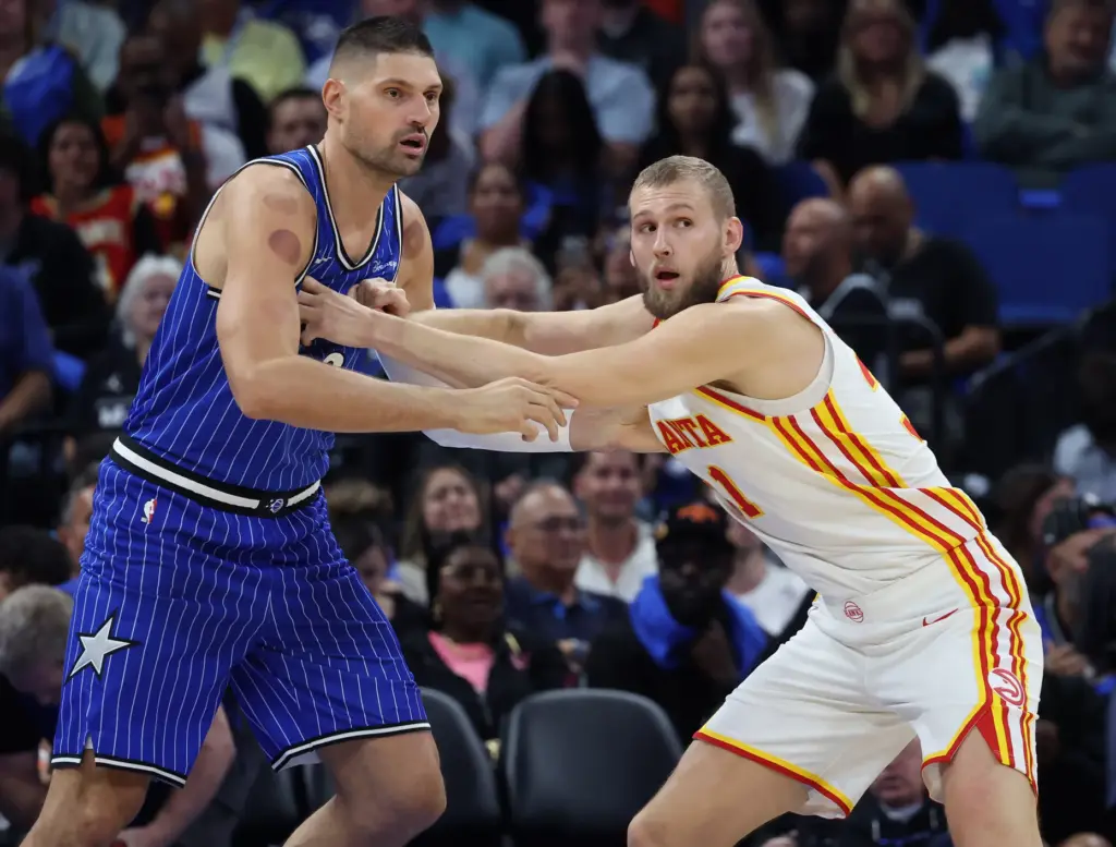 Orlando center Nikola Vucevic (left) and Atlanta center Jock Landale...