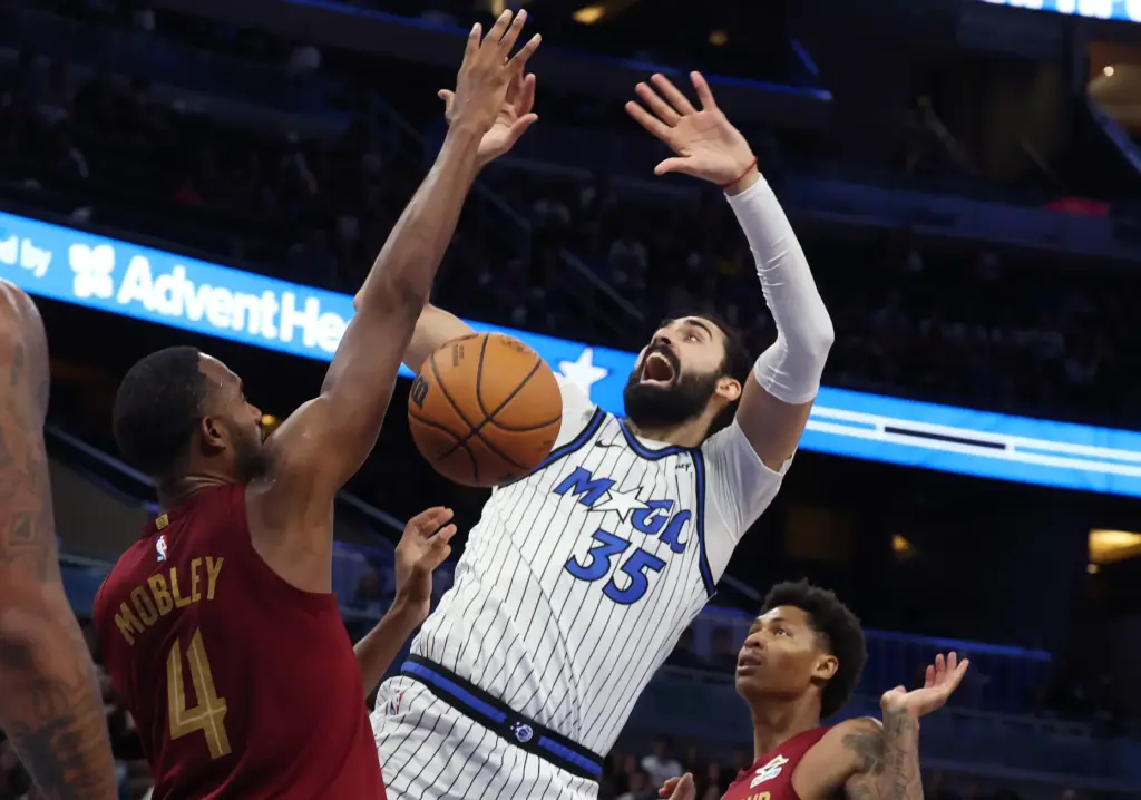 Orlando center Goga Bitadze (35) battles between Cleveland players Evan...