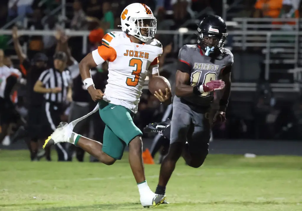 Jones High receiver Damir Williams (3) runs for a touchdown...
