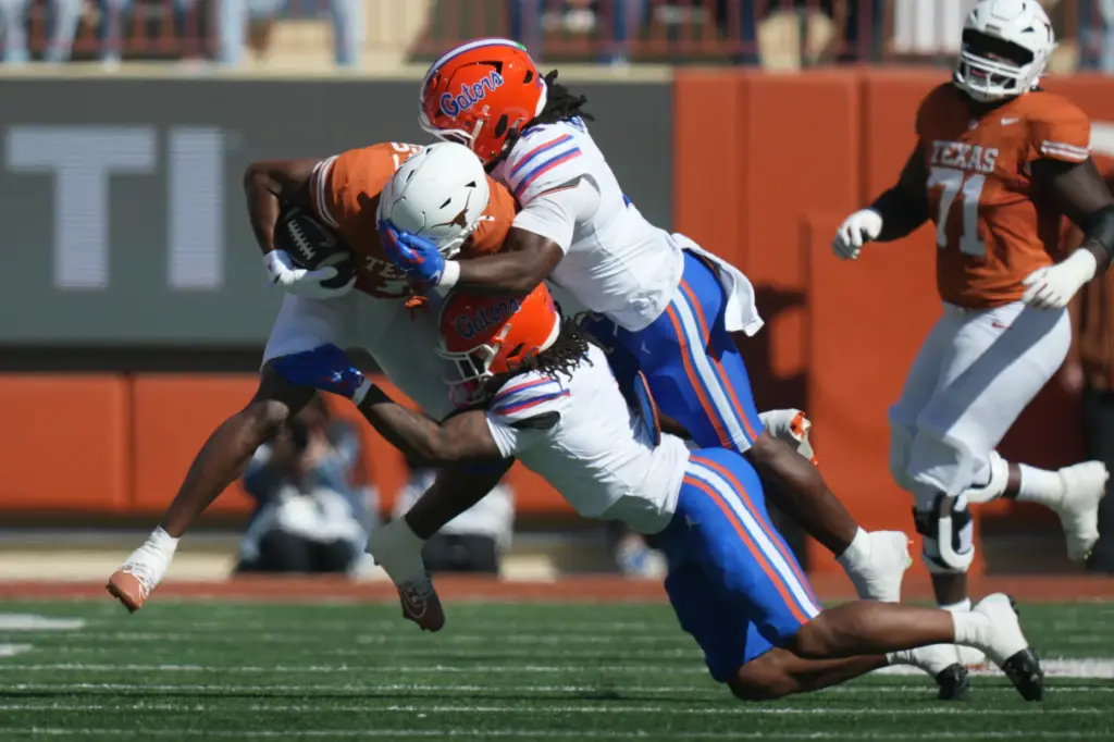 Texas wide receiver Ryan Wingo (1) is hit by Florida...