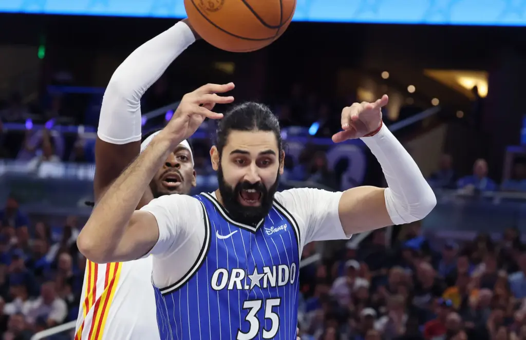 Orlando center Goga Bitadze (35) and Atlanta guard Luguentz Dort...