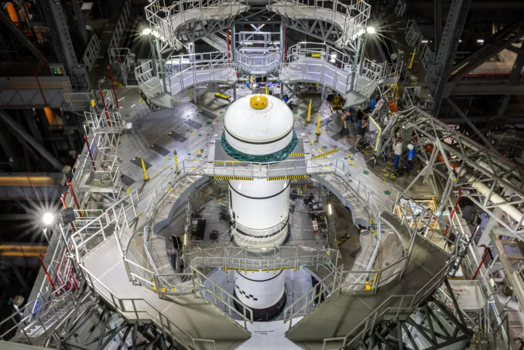 Technicians integrate the left forward booster segment for NASA's Artemis...