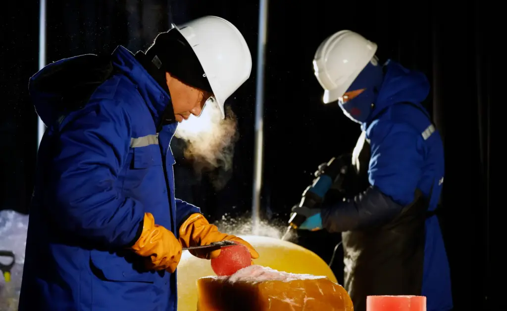 Master ice artisans from Harbin, China, at work during a...