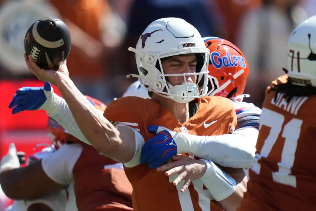 Texas quarterback Arch Manning (16) is hit by Florida linebacker...