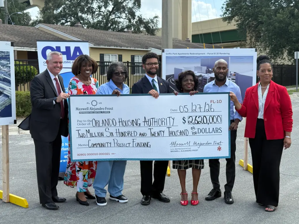 Members of the Orlando Housing Authority are joined by U.S....