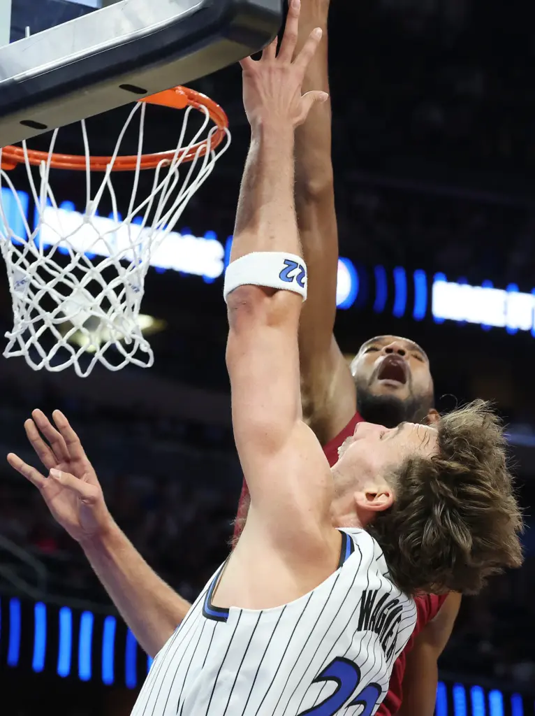 Orlando forward Franz Wagner (22) shoots under Cleveland center Evan...