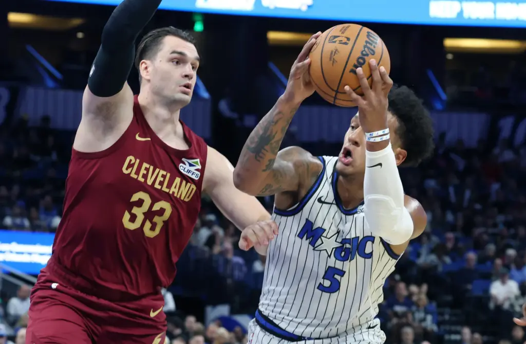Orlando forward Paolo Banchero (5) grabs a rebound beside Cleveland...