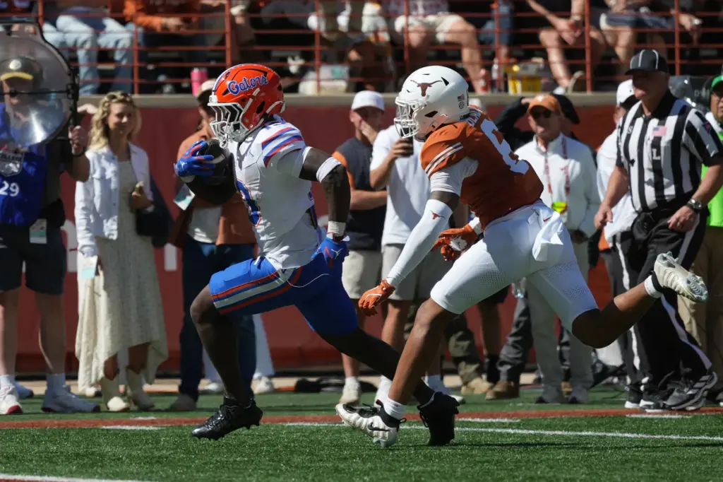 Florida running back Jadan Baugh (13) runs past Texas defensive back Kobe Black (6) for an 11-yard touchdown during the Gators' 27-24 win at Texas Saturday in Austin. (AP Photo/Eric Gay)