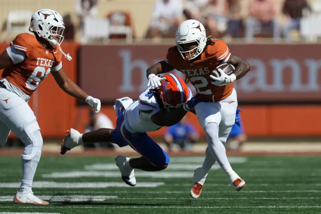 Texas running back Hollywood Smothers (2) is hit by Florida...