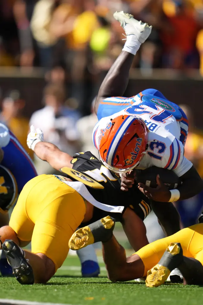 Florida running back Jadan Baugh (13) is stopped by Missouri linebacker Nicholas Rodriguez during the Gators' 45-10 loss Saturday in Columbia, Missouri. Baugh finished with just 13 rushing yards. (AP Photo/Jeff Roberson)