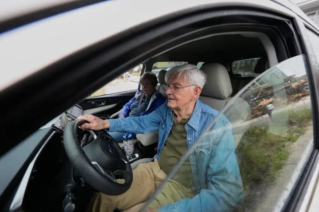Frank Winn, 84, evacuates with his wife from his home...