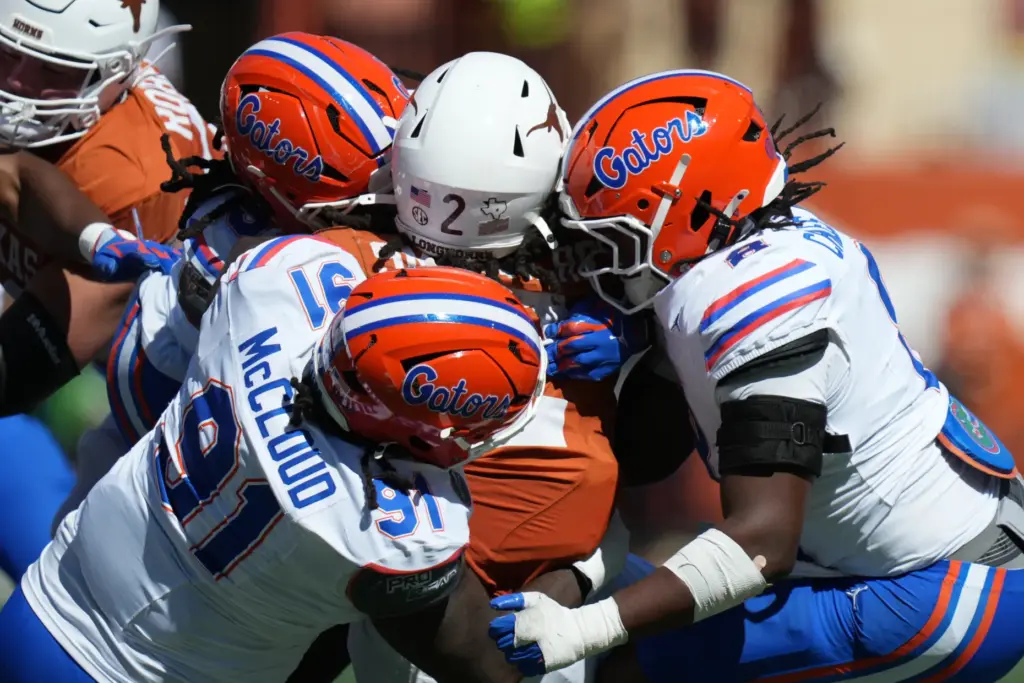Texas running back Hollywood Smothers (2) is stopped by Florida...