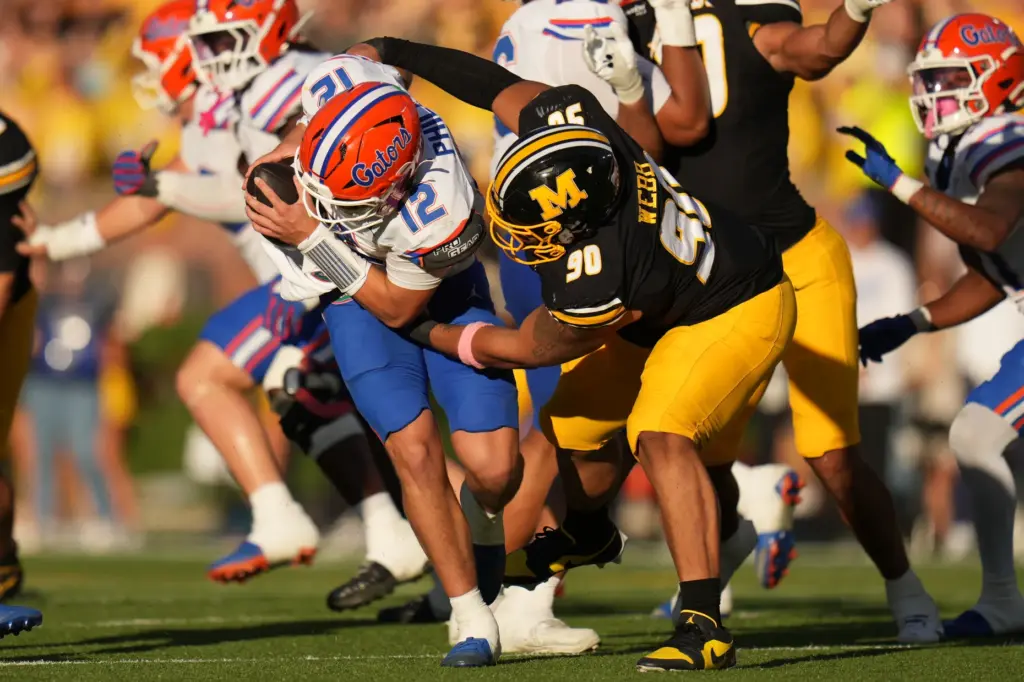 Florida quarterback Aaron Philo (12) is sacked by Missouri defensive...