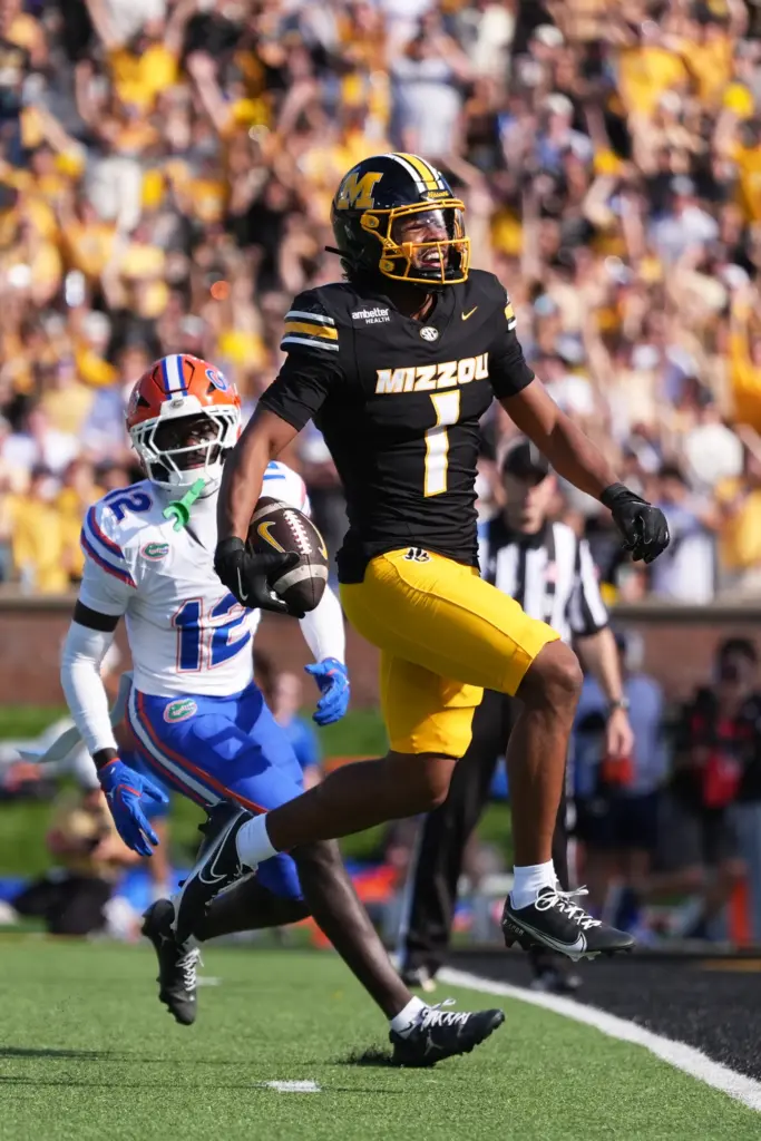 Missouri wide receiver Donovan Olugbode (1) scores past Florida cornerback...