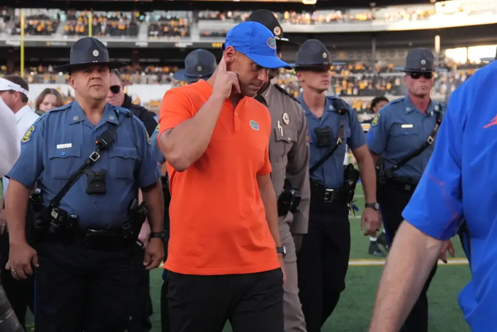 Florida head coach Jon Sumrall heads off the field following...